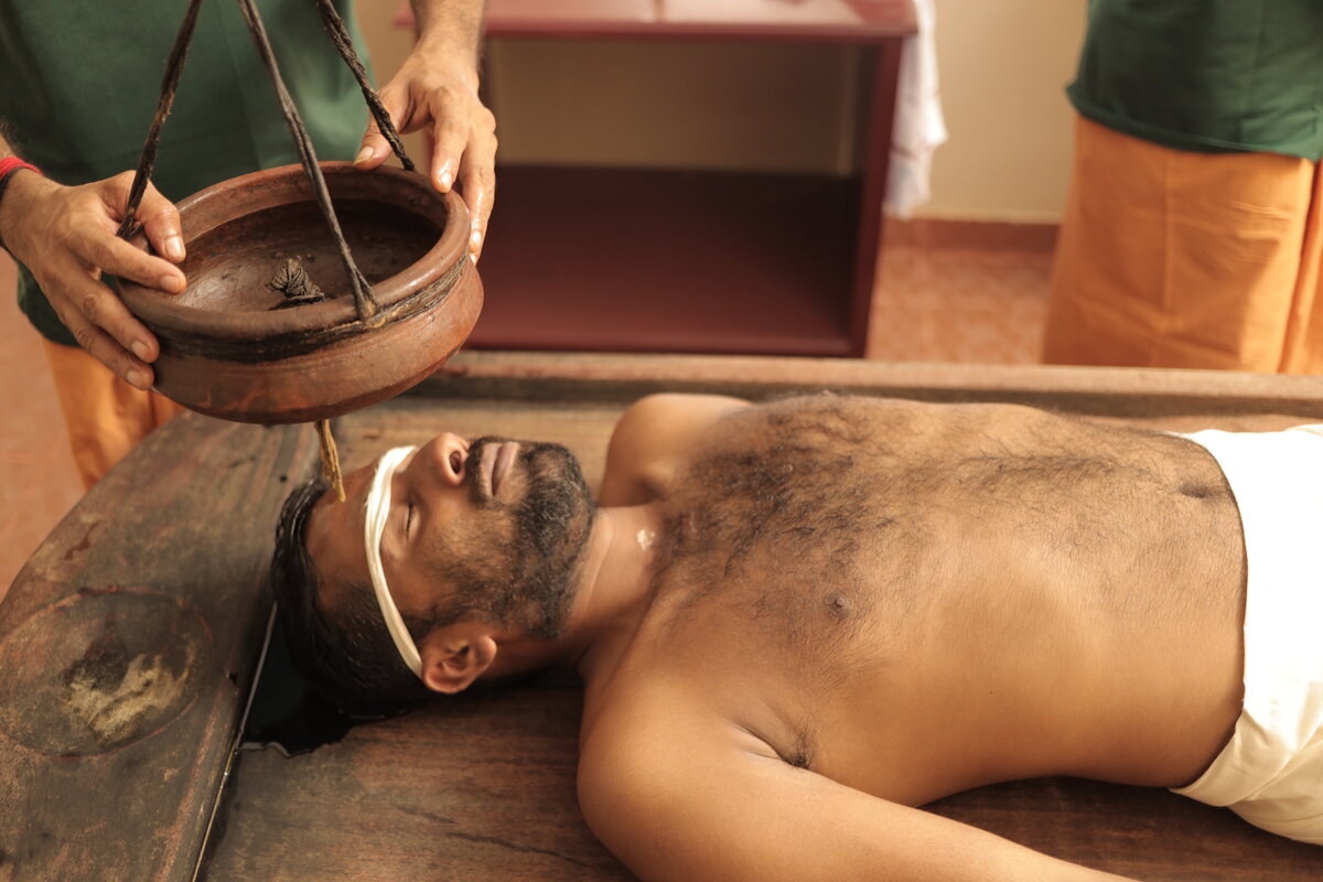 Shirodhara treatment - warm oil poured on forehead